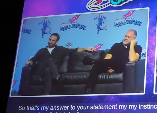 Terrible photo of a projection screen with a half-sized view of Charlie Cox and Vincent D'Onofrio in comfy seats on stage. Subtitles are running underneath.