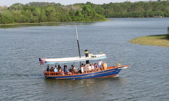 Ferry full of passengers on the sunny lagoon.