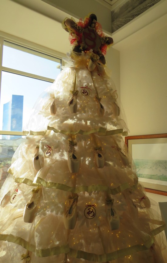 White Christmas tree covered in ballet slippers.