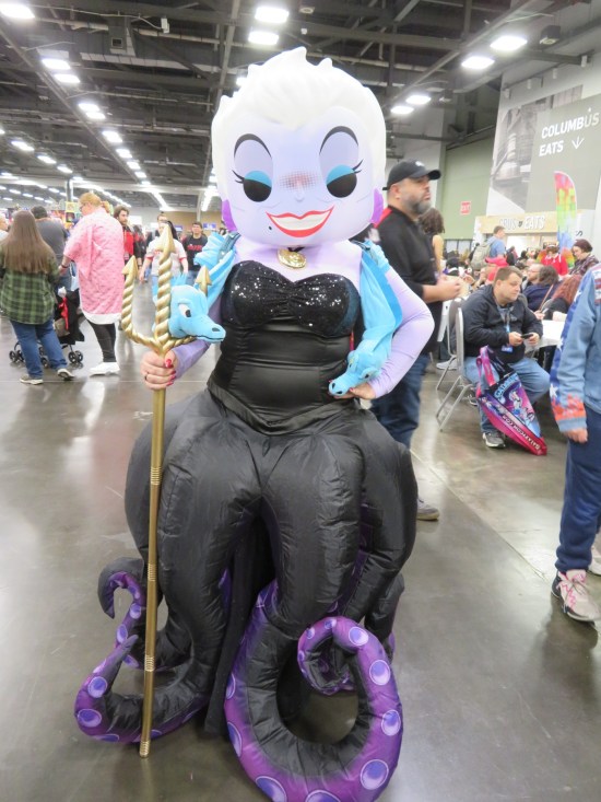 inflatable Ursula costume with a trident and two eels around her neck.