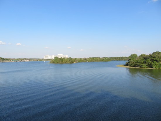 Ripples across the lagoon. A large white hotel is on the horizon.