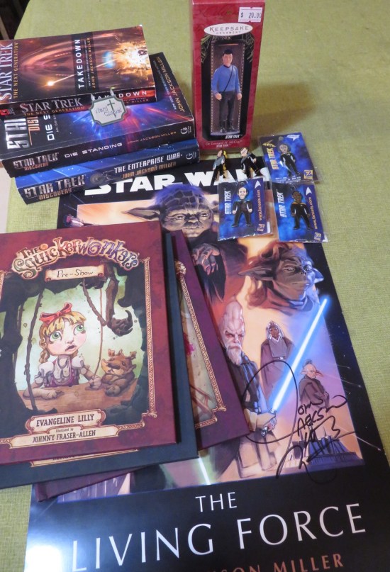 Stuff we bought including Trek pins, Trek books, Dr. McCoy ornament, Star Wars poster, and three free Squickerwonkers books.
