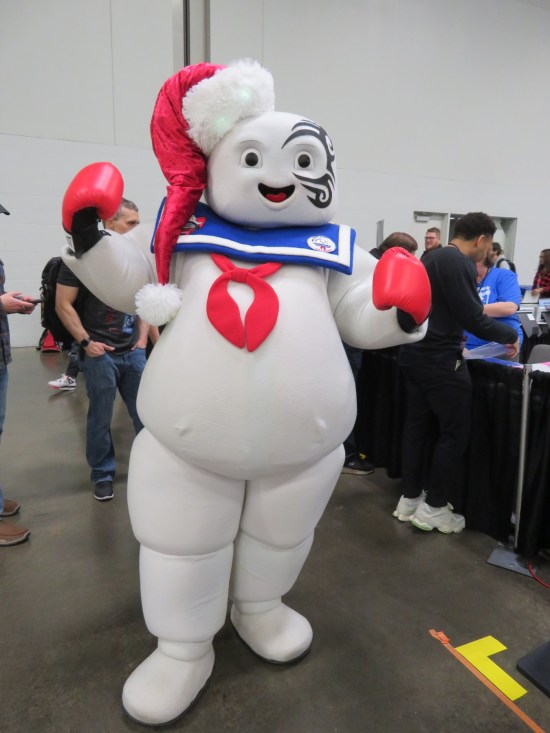 Stay Puft cosplayer wearing a Santa hat and boxing gloves, plus a face tattoo exactly like Mike Tyson's.