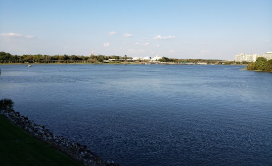Sunny day on a large body of water with Disney World details on the horizon.