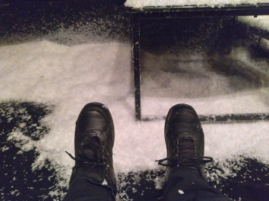 Anne's black shoes flecked with fake snow. Lots more snow is piled at the edge of the stage and on the modular stairs leading up to it.