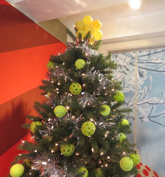 Christmas tree covered in yellow Wiffle balls.