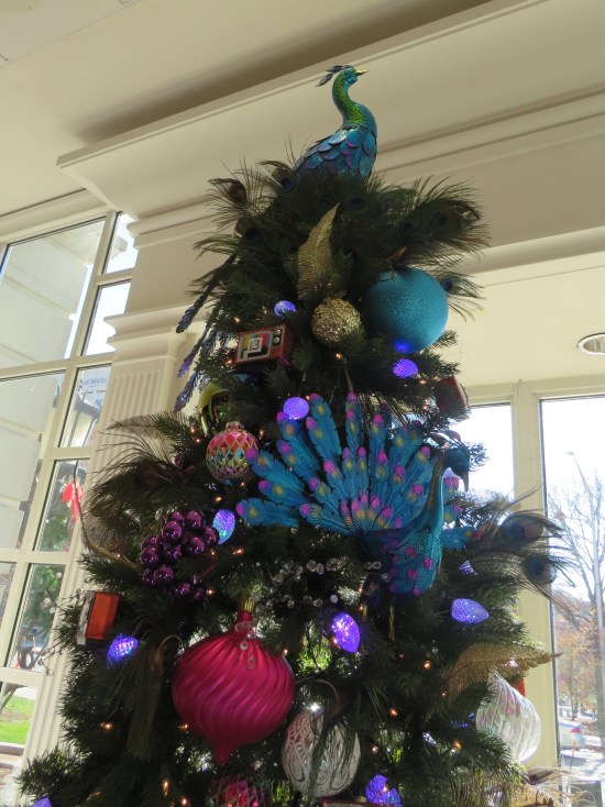 Christmas tree with a peacock decoration motif.