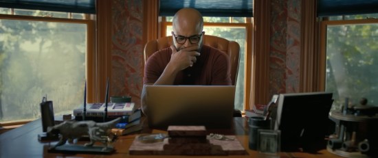 Jeffrey Wright as an author sitting at his laptop in a very nice house, thinking hard about his next sentence.