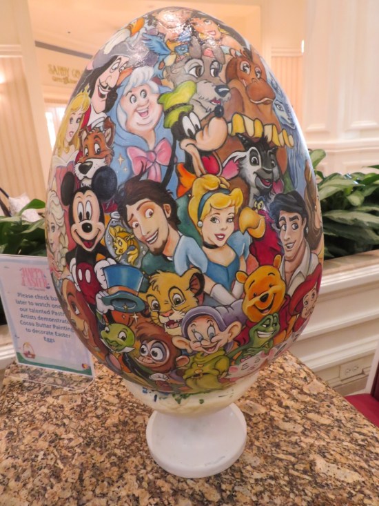 Large egg with nearly two dozen Disney characters painted on it.