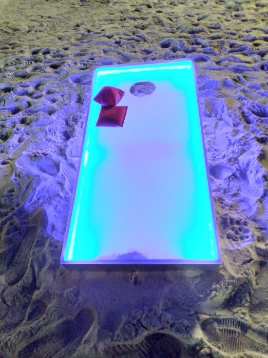 Bean bags laid on some kind of rectangular glowing table or platform.