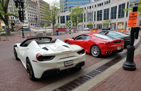 Expensive sports cars parked around Monument Circle in downtown Indianapolis.