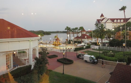 Resort grounds including a water jungle gym, palm trees, wide brick paths, and the lagoon.