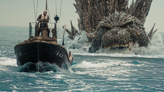 Godzilla's angry giant head poking out of the water as he chases a small boat with our four human heroes on it, all frightened out of their wits.