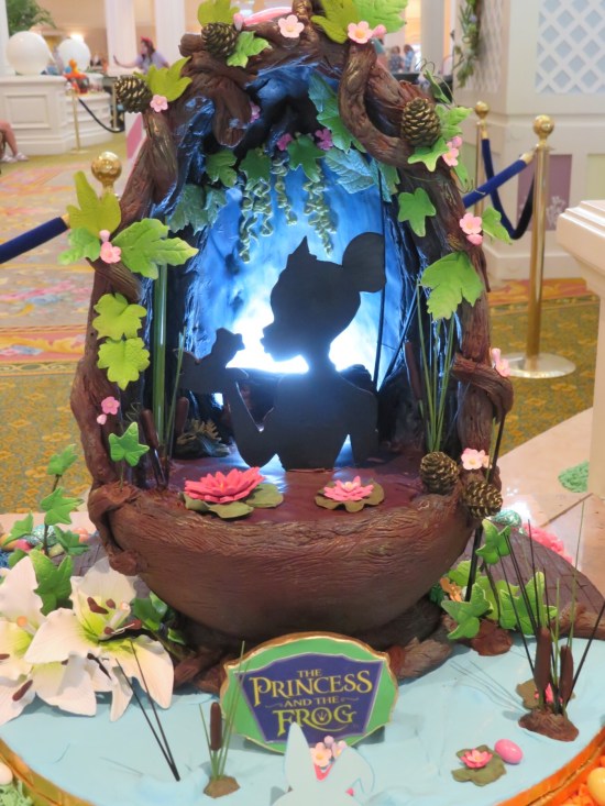 Egg painted with silhouette of Princess Tiana kissing a frog.