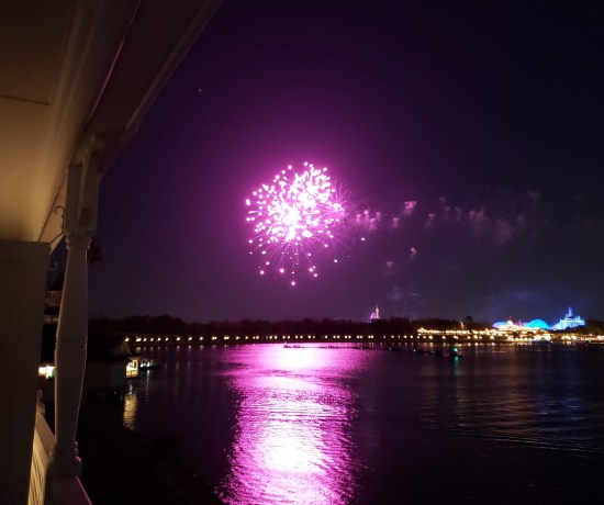 Distant fireworks over water.  Large purple ball, reflecting straight across the water, no balcony blocking it this time.