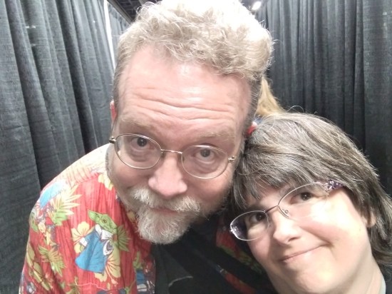 Anne and me taking a true selfie amid a hallway of black curtains. We are exhausted but weakly smiling anyway.