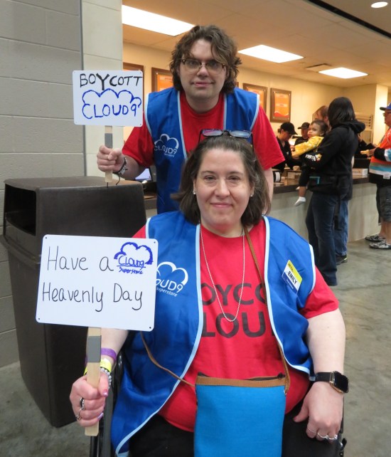 cosplay: Cloud 9 employees wearing shirts that both say "Boycott Cloud 9". They hold tiny picket signs reading "Boycott Cloud 9" and "Have a heavenly day."