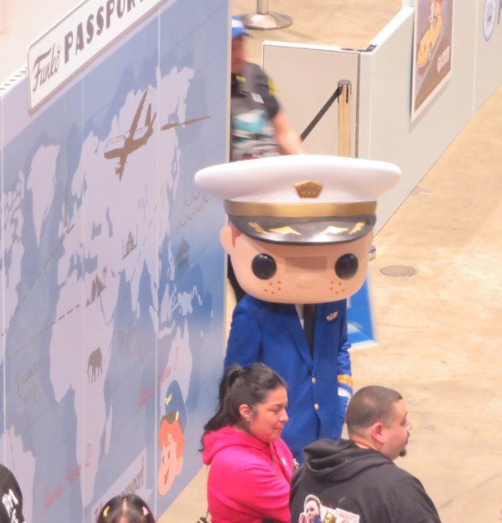 Guy costumed as a Funko Pop in a pilot's uniform.