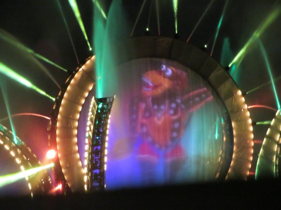 Stargate closeup with cartoon monkey who is NOT Apu or King Louie. Pillars are revealed to be light rigs in our best shot of them.