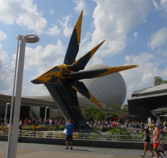 Spaceship standing in the middle of a theme park. That familiar Spaceship Earth golf ball looms even larger behind it.