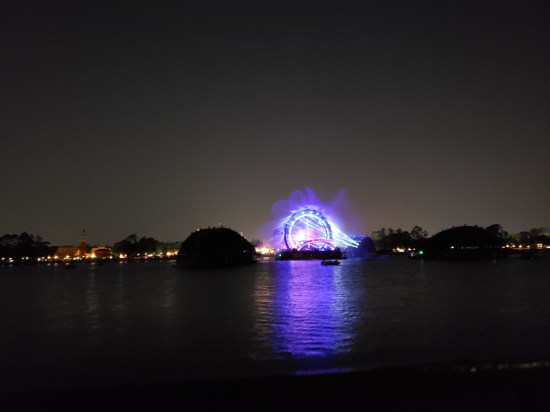 Purple circle light gate across an otherwise dark lagoon at night.