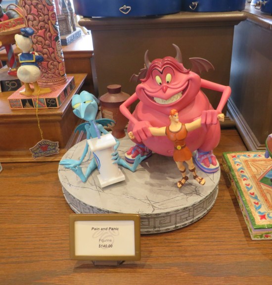 Figurines of the characters Pain and Panic from Disney's Hercules movie. Panic is sipping a soft drink. Pain is yanking on the arms of a stretchy Hercules toy. Price is $140.00.