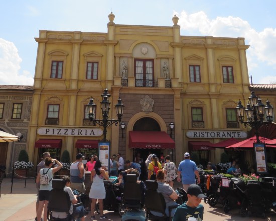 Three-story-tall faux Italian eatery called Pizzeria Ristorante. Customers are lined out the door. Luckily for them it's a sunny day.
