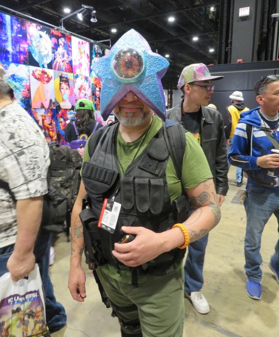 Soldier cosplayer with a Starro alien starfish attached to his head.