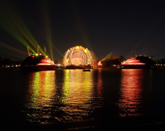 Yellow stargate, two yellow archways across dark night waters.