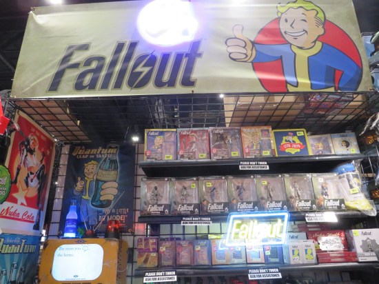 Shelves full of  Fallout merchandise starring their cute mascot Vault Boy.
