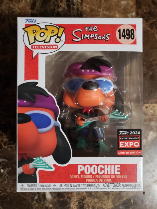 A Funko Pop of Poochie the Dog from "The Simpsons". It bears a tiny sticker saying "Funko 2024 Entertainment Expo Exclusive Edition" in red, black, and white, same colors and font as C2E2's own.