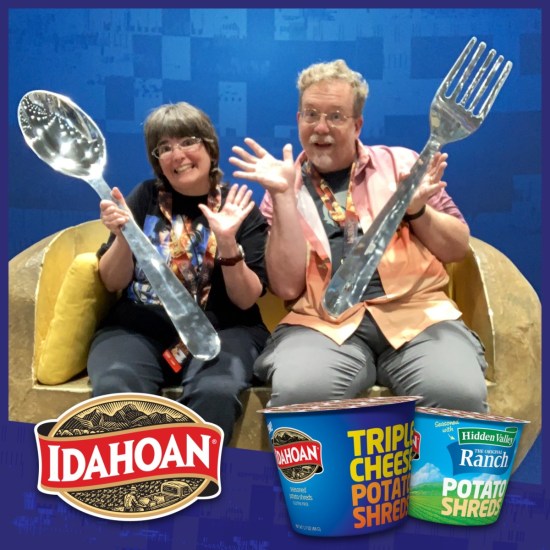 Me and Anne in a terribly edited photo with microwaveable potato products, each of us holding a giant spoon and fork.