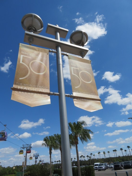 Brownish street light banners advertising Disney World's 50th anniversary, "The World's Most Magical Celebration".