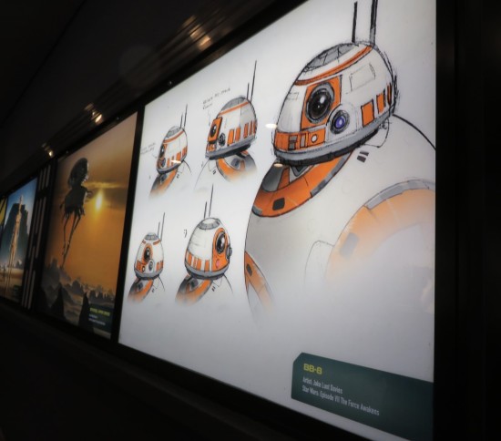 Angled shot of a large HDTV showing five drawings of BB-8's head - black, white and orange.