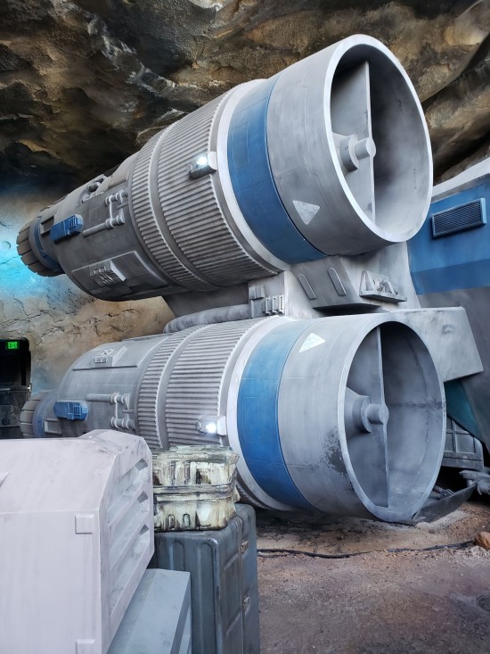 Engines on the back of the prison spaceship. Gray with blue bands on each rocket.
