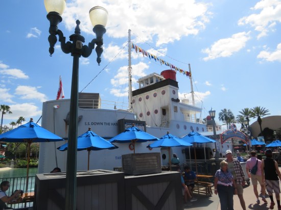 Diner shaped like a cartoon tugboat christened the SS Down the Hatch, parked by a pond.