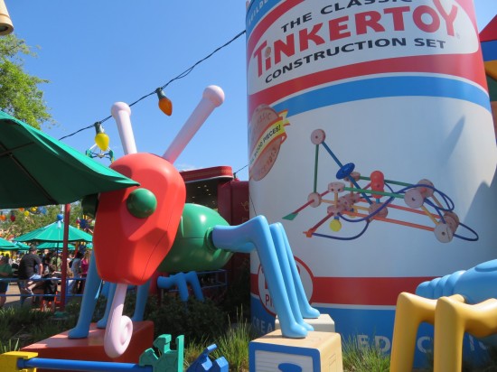 Giant Tinkertoy container and a big plastic ant built from plastic toy parts.