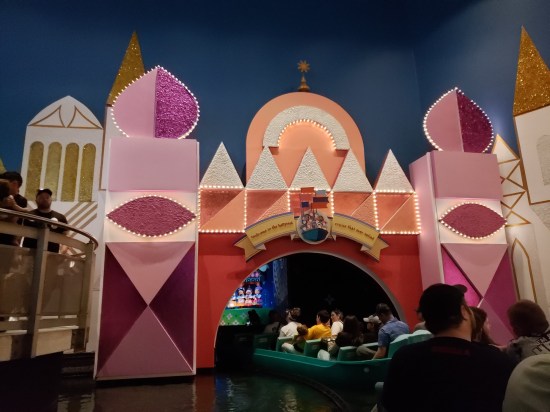 Boat ride through orange castle archway that reads "Welcome to the happiest cruise that ever sailed."