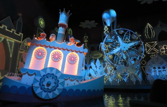 cutesy singing animatronic figurines on a blue ferry and a blue Ferris wheel.