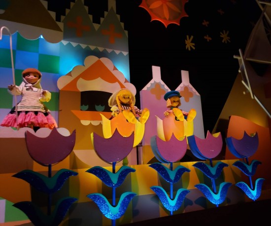 cutesy singing animatronic figurines, Dutch costumes and sitting in large tulips.