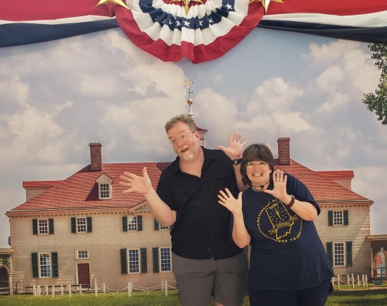 Us doing jazz hands in front of an enlarged photo of George Washington's mansion.