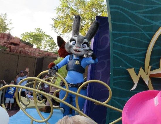 Disney World cast member dressed as a stuffed Officer Judy Hopps on the back of a float.