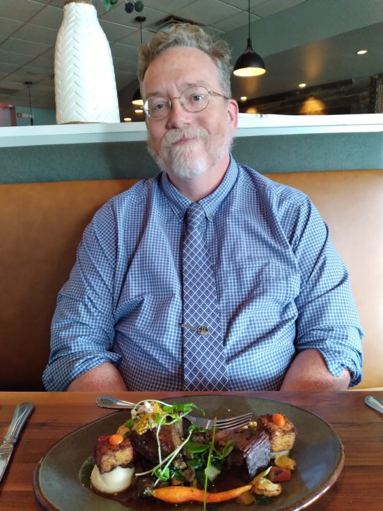 Me in the same booth, in a checkered blue shirt and a tie that Anne designed online.