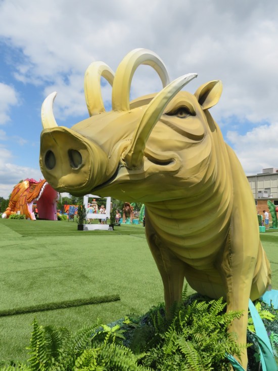 Large yellow babirusa sculpture.