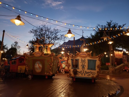 Fake circus train cars in a circle along a Magic Kingdom path.