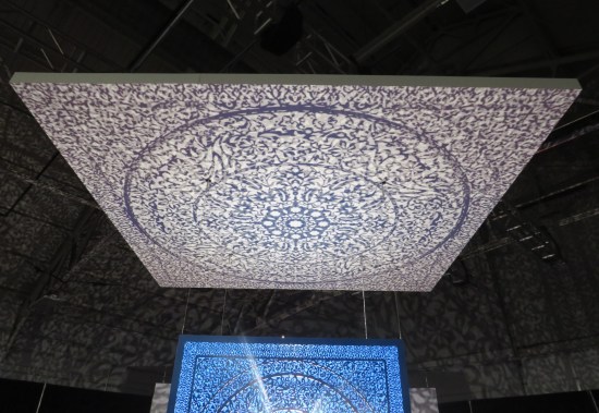 Blue cube casts intricate flower shadows onto platform above.