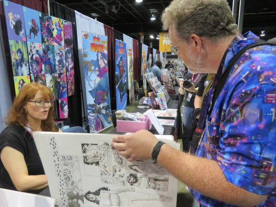 Me leafing through Nicola Scott's original art, which she's talking about as we go.