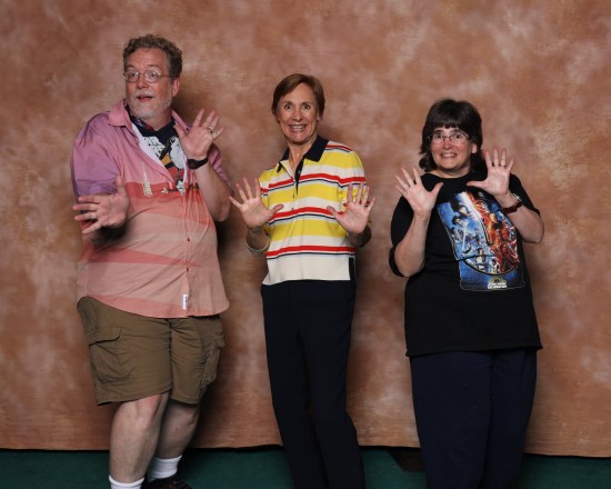 Us doing jazz hands with Laurie Metcalf against a swirling beige backdrop.