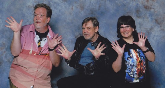 Us doing jazz hands with Mark Hamill, who's seated in a bar chair.