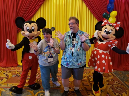 Us doing jazz hands with Mickey and Minnie Mouse.